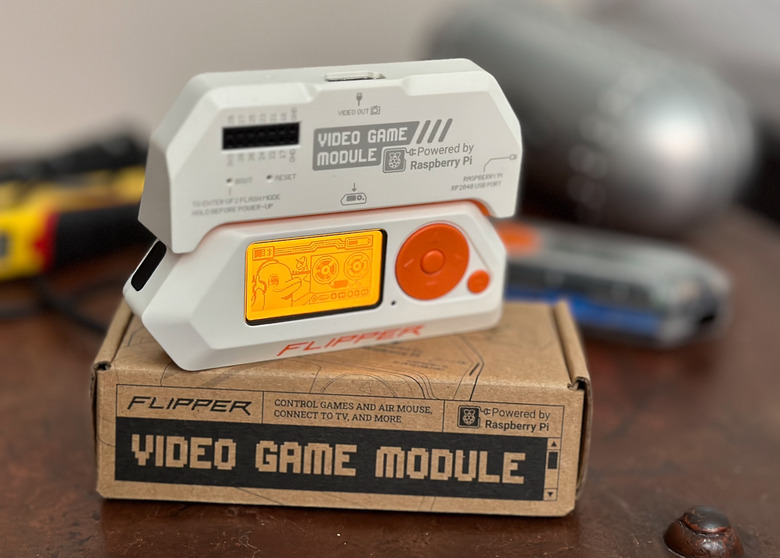 A Flipper Zero attached to a module on top of a box. 