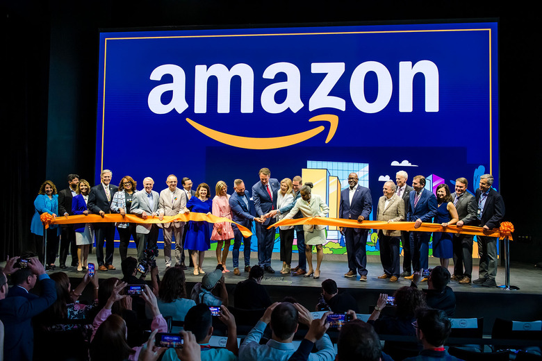 Amazon staffers joyfully cut a ribbon (with Virginia governor Glenn Youngkin) at a ceremony for its second headquarters.