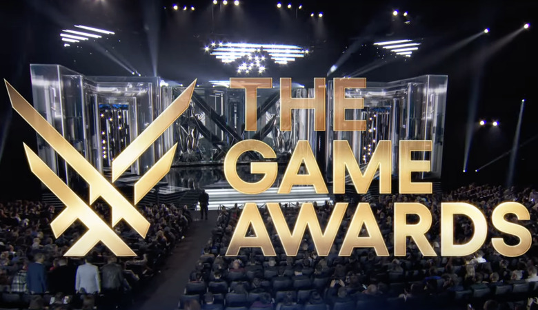The Game Awards Title and logo in gold lettering pictured over a live view of a seated audience