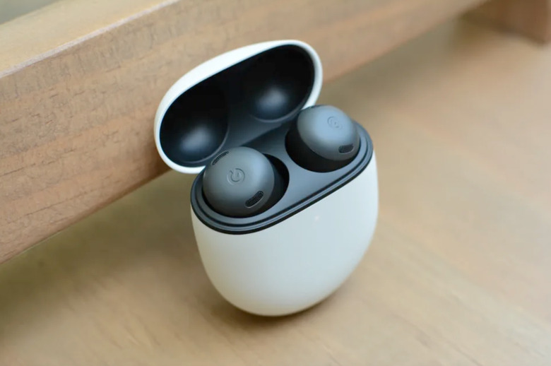 The earbuds in the case on a desk. 