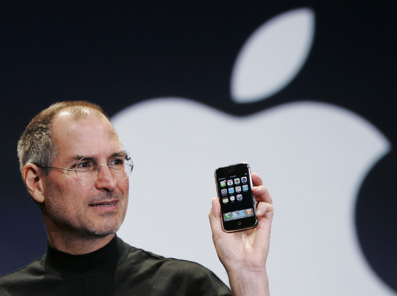 FILE- In this Jan. 9, 2007, file photo, Apple CEO Steve Jobs holds up an iPhone at the MacWorld Conference in San Francisco. Jobs introduced the first iPhone a decade ago. Jobs' 