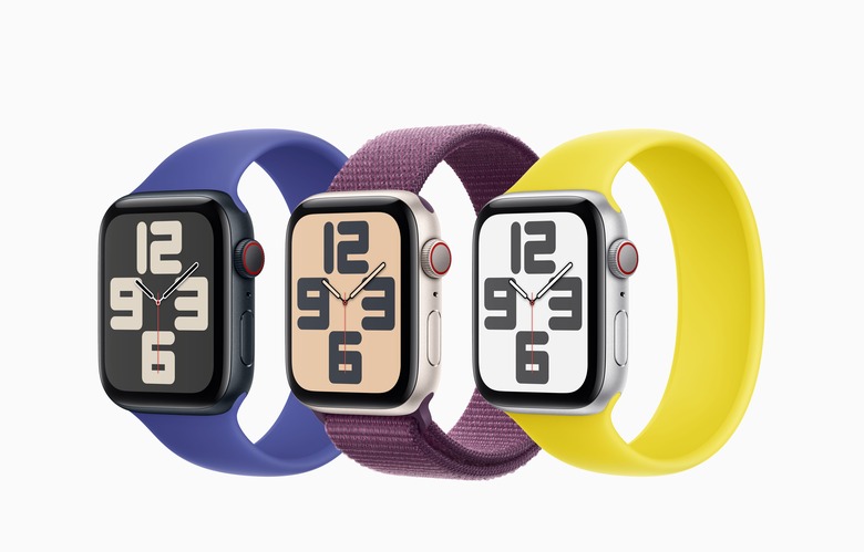 Three second generation Apple Watch SE 2s pictured with a blue, purple and yellow band against a white background