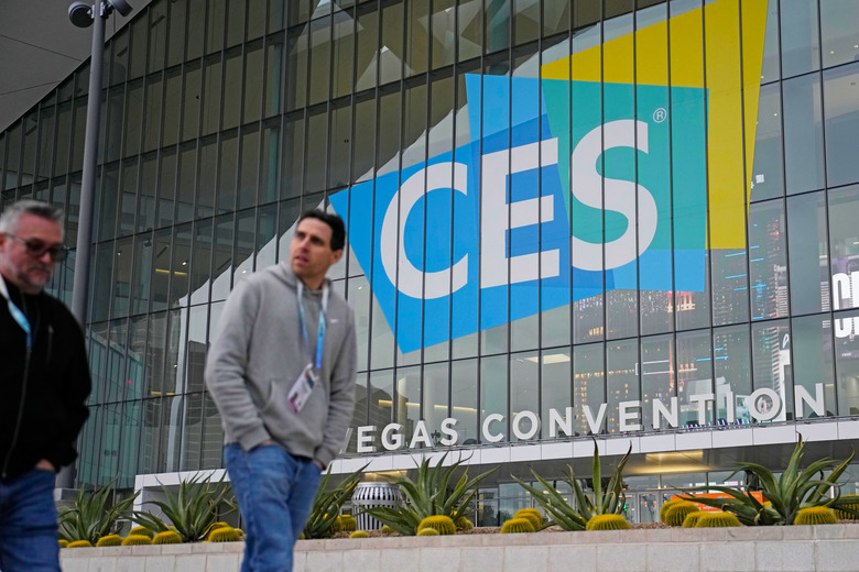 People walk by the Las Vegas Convention Center during setup ahead of the CES tech show Saturday, Jan. 6, 2024, in Las Vegas.