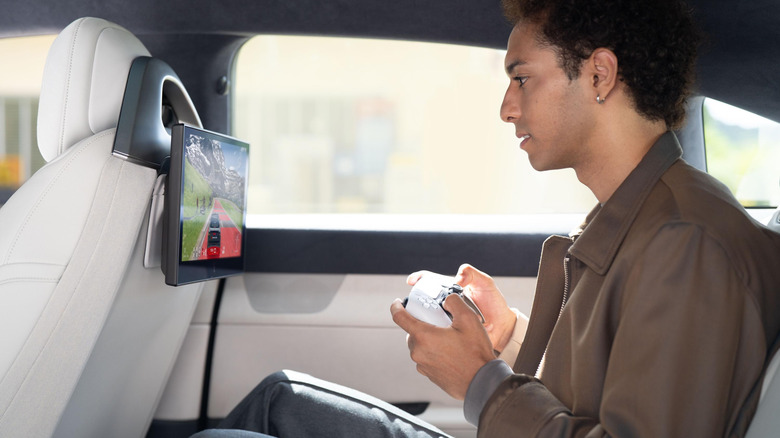 A passenger in the Afeela 1 playing PS Remote Play.