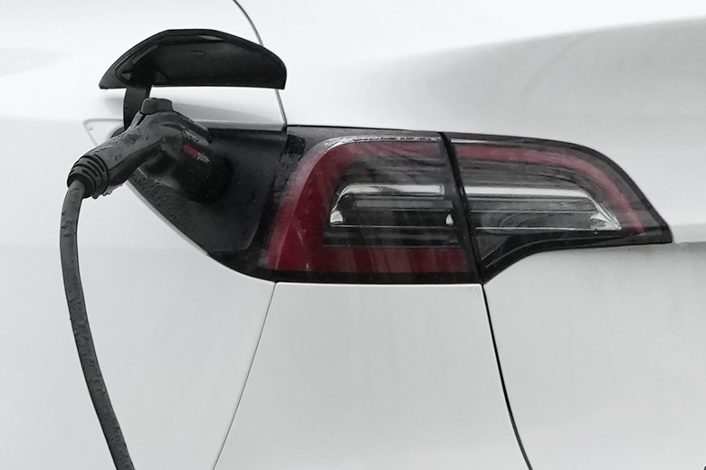 A Tesla vehicle is charged by a EV charging station in Wheeling, Ill., Tuesday, Jan. 23, 2024. (AP Photo/Nam Y. Huh)