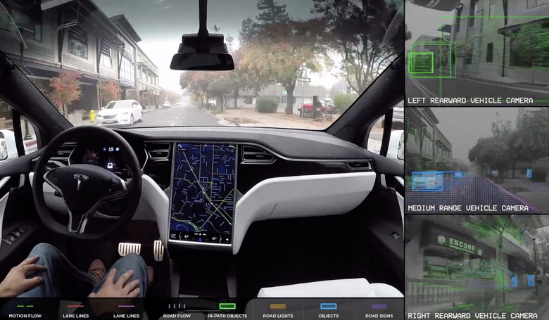 A person in a car with their hands on their lap instead of the steering wheel.