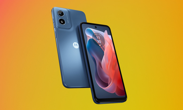 Product marketing image of the Moto G Play (in blue with a blue and red wallpaper). Two phones (one front-facing and one back-facing) sit in front of an orange-yellow gradient background.