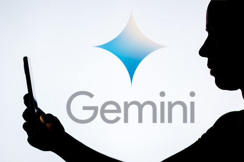 BRAZIL - 2022/03/21: In this photo illustration, a woman's silhouette holds a smartphone with the Google Gemini logo in the background. (Photo Illustration by Rafael Henrique/SOPA Images/LightRocket via Getty Images)