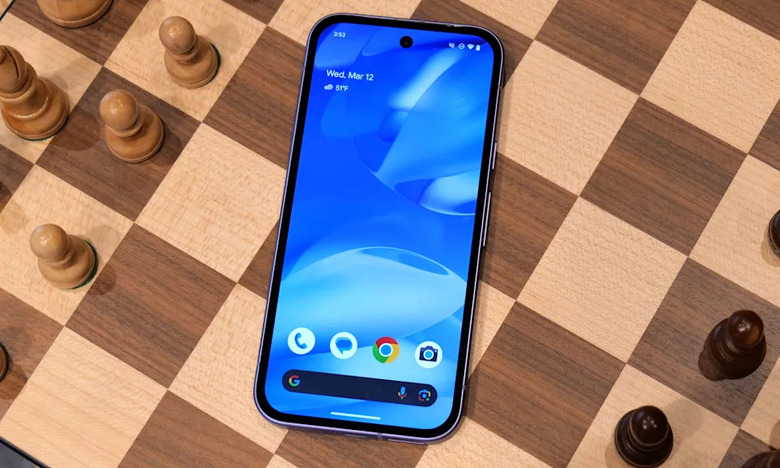 The Google Pixel 9a smartphone sitting on a chess board.
