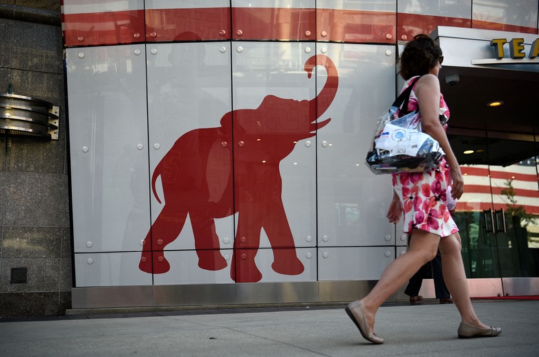 A woman walks past the elephant logo of the Republican Party on the first day of the  Republican National Convention on July 18, 2016 in Cleveland, Ohio. The Republican Party opened its national convention, kicking off a four-day political jamboree that will anoint billionaire Donald Trump as its presidential nominee. (Photo by DOMINICK REUTER / AFP) (Photo by DOMINICK REUTER/AFP via Getty Images)