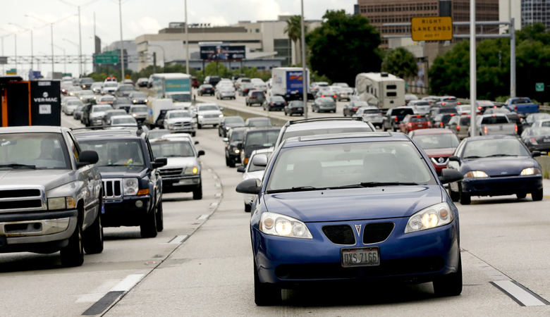 In this Tuesday, June 23, 2015 photo, rush hour traffic makes its way along Interstate 4 in Orlando, Fla. The longest average commute in Florida is found in the Cape Coral-Fort Myers metro area, Port St. Lucie and Orlando metro areas are tied for third place. (AP Photo/John Raoux)