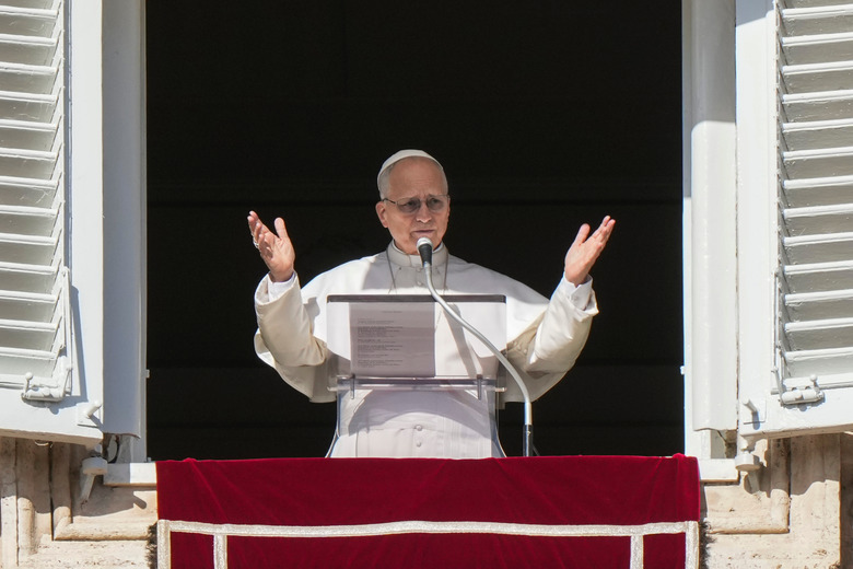 Pope Leo XIV addresses the faithful gathered in St. Peter's Square at the Vatican for the traditional Sunday blessing at the end of the Angelus prayer, Sunday, Jan. 25, 2026. (AP Photo/Andrew Medichini)