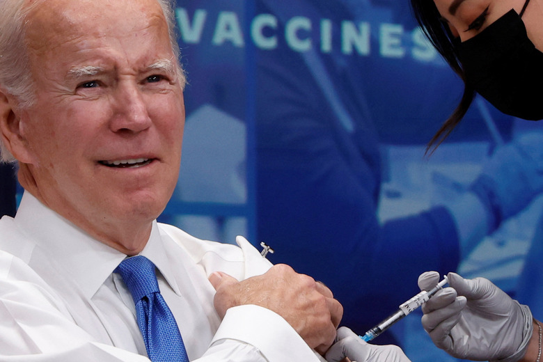U.S. President Joe Biden receives an updated coronavirus disease (COVID-19) vaccine onstage in an auditorium on the White House campus in Washington, U.S. October 25, 2022. REUTERS/Jonathan Ernst