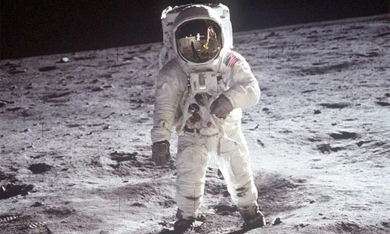 Archival photo of Neil Armstrong (in spacesuit) on the Moon’s surface in 1969.