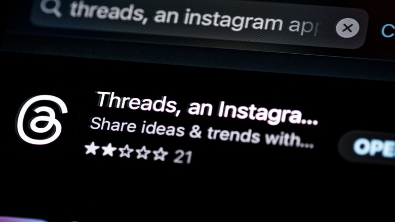 A black and white logo for Threads in the app store. 