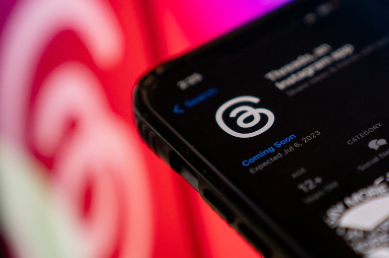 TOPSHOT - This photo illustration created in Washington, DC, on July 5, 2023, shows Threads, an Instagram app, on the App Store, in front of the logos of Instagram and Threads. Facebook owner Meta's new Threads app, meant to compete with Twitter, was available for pre-order on mobile app stores on iPhone and Android operating systems on July 5, 2023. Listed as 