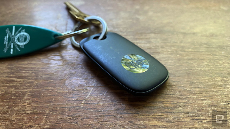 The tile pro Bluetooth tracker is attached to a key ring with one key on it. 
