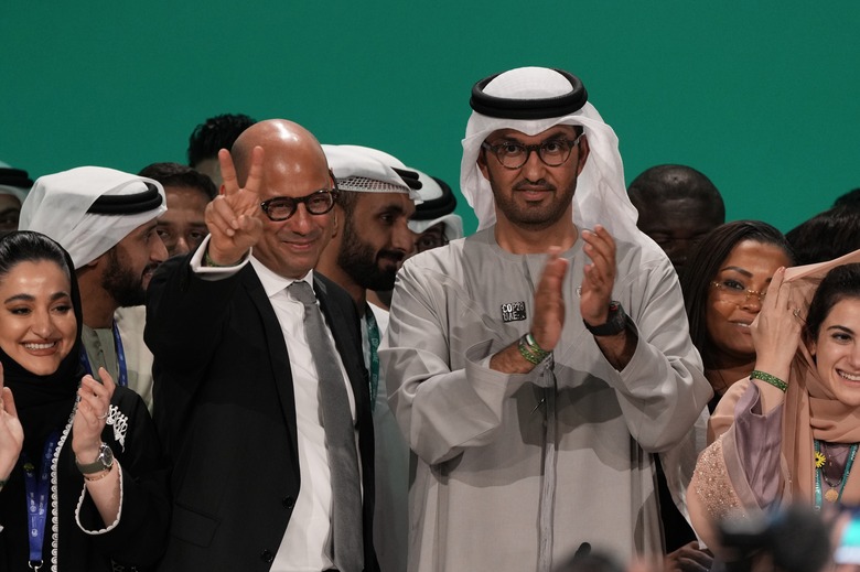 United Nations Climate Chief Simon Stiell, from left, and COP28 President Sultan al-Jaber pose for photos at the end of the COP28 U.N. Climate Summit, Wednesday, Dec. 13, 2023, in Dubai, United Arab Emirates. (AP Photo/Kamran Jebreili)