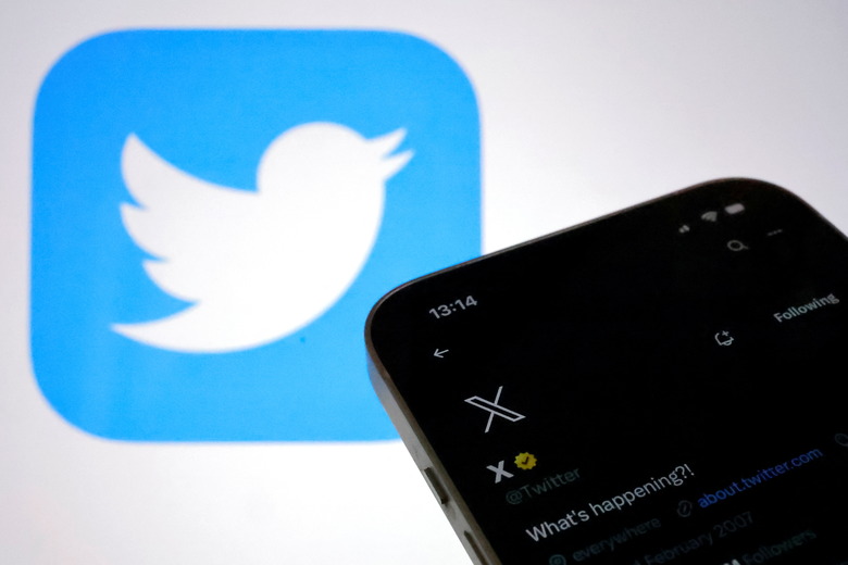 The new logo of Twitter is seen on an iPhone as the old Twitter logo is displayed on a MacBook screen in Galway, Ireland July 24, 2023. REUTERS/Clodagh Kilcoyne