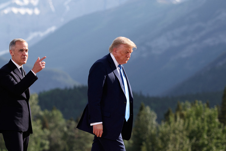 Canada's Prime Minister Mark Carney, left, and U.S. President Donald Trump leave after a family photo session during the G7 Summit, in Kananaskis, Alberta, Monday, June 16, 2025. (Suzanne Plunkett/Pool Photo via AP)