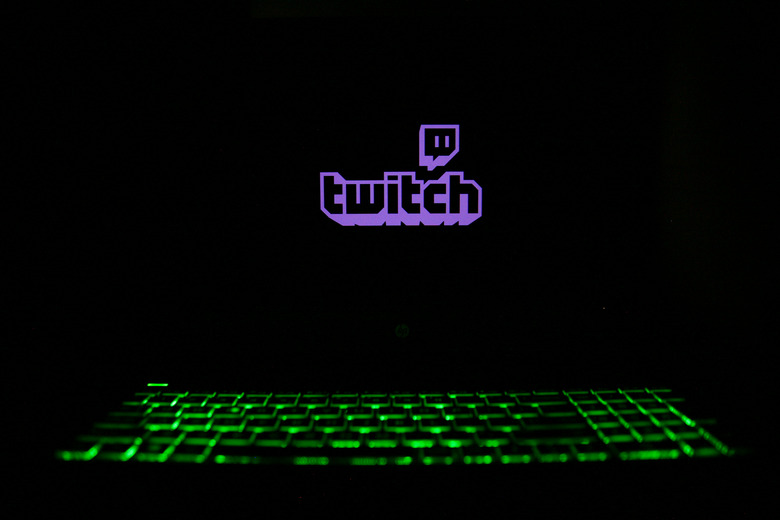 The Twitch logo is displayed on a laptop screen with a glowing keyboard in Krakow, Poland, on March 3, 2024. (Photo by Klaudia Radecka/NurPhoto via Getty Images)