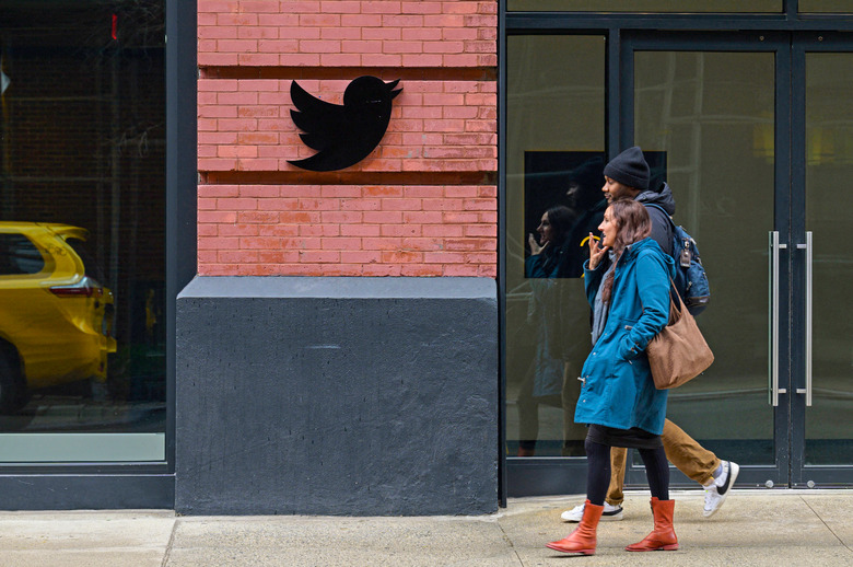 People walk past the Twitter offices in New York City on January 12, 2023. 