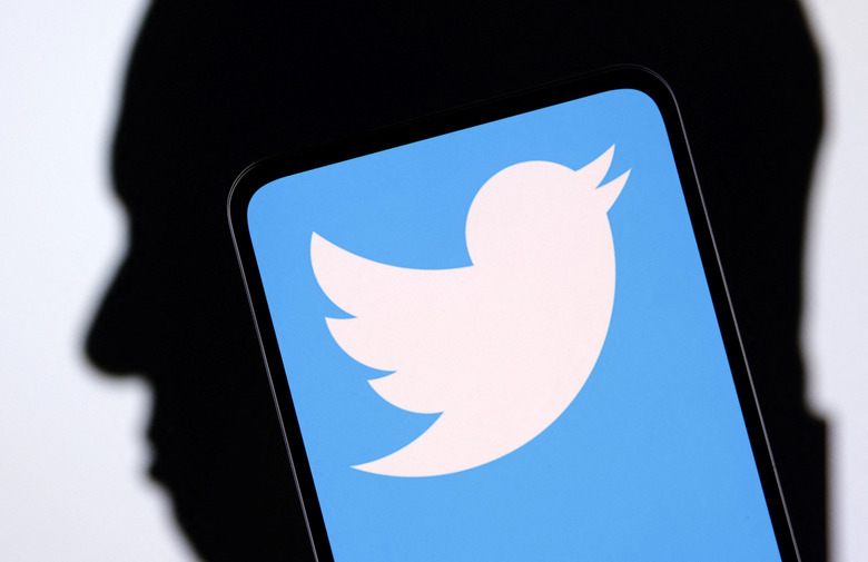 Twitter logo and Elon Musk silhouette are seen in this illustration taken, December 19, 2022. REUTERS/Dado Ruvic/Illustration