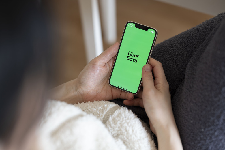 JAPAN - 2024/03/17: In this photo illustration, the Uber Eats app seen displayed on a mobile phone. Uber Eats started using self-driving robots for delivering food orders to customers in Tokyo in March 2024. (Photo Illustration by Stanislav Kogiku/SOPA Images/LightRocket via Getty Images)