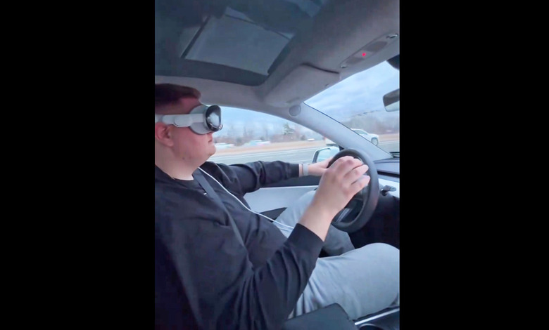 A screenshot from a video posted on X by Dante Lentini of him driving down the highway while wearing an Apple Vision Pro headset.  