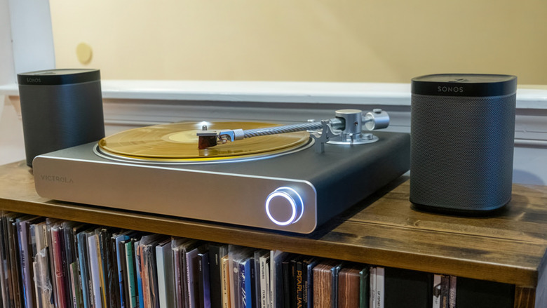 Photo of the Victrola Stream Carbon sitting on a shelf housed with vinyl.