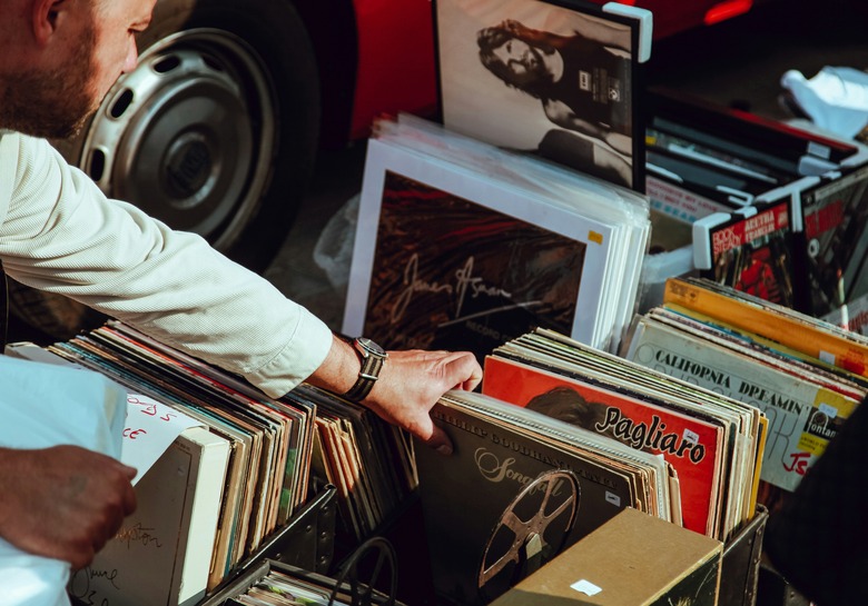 A person looks through some vinyl records.