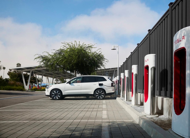 A Volvo EV charging at a Tesla Supercharger
