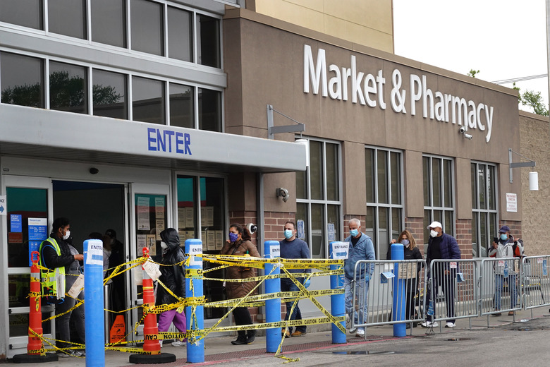 CHICAGO, ILLINOIS - MAY 19: Customers wait in line to enter a Walmart store on May 19, 2020 in Chicago, Illinois. Walmart reported a 74% increase in U.S. online sales for the quarter that ended April 30, and a 10% increase in same store sales for the same period as the effects of the coronavirus helped to boost sales. (Photo by Scott Olson/Getty Images)