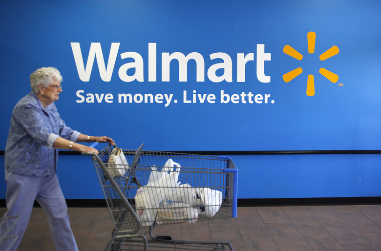 A customer leaves a Wal-Mart store in Rogers, Arkansas June 4, 2009. Wal-Mart Stores Inc said on Thursday that its strong financial position leaves it well positioned to take advantage of acquisition opportunities across the globe.      REUTERS/Jessica Rinaldi (UNITED STATES BUSINESS)