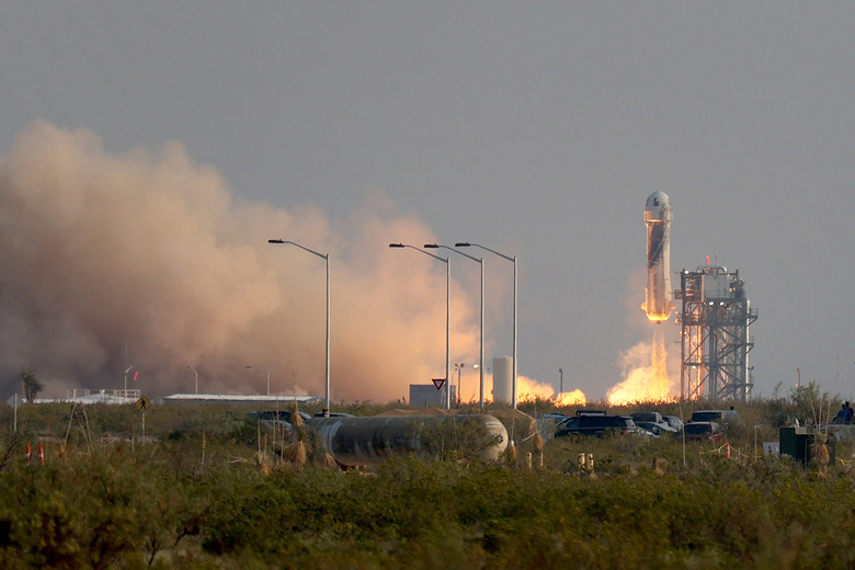 VAN HORN, TEXAS - JULY 20:  The New Shepard Blue Origin rocket lifts-off from the launch pad carrying Jeff Bezos along with his brother Mark Bezos, 18-year-old Oliver Daemen, and 82-year-old Wally Funk prepare to launch on July 20, 2021 in Van Horn, Texas. Mr. Bezos and the crew are riding in the first human spaceflight for the company.   (Photo by Joe Raedle/Getty Images)
