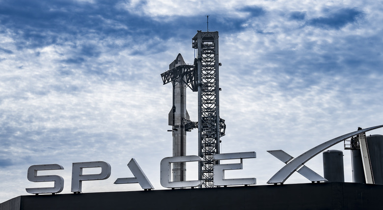 SpaceX's Starship on the launchpad and the SpaceX logo.