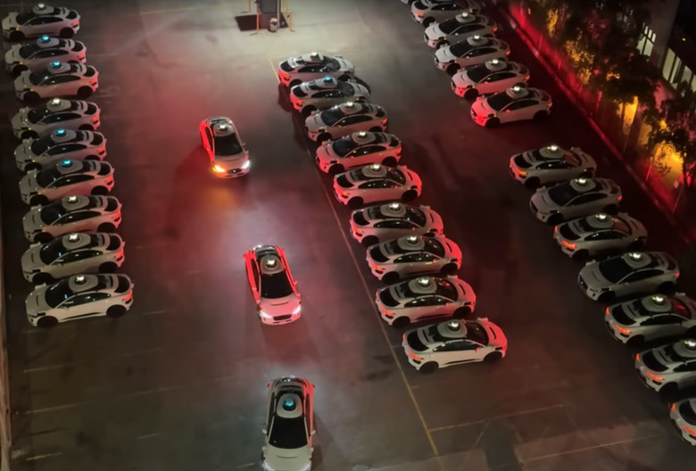 A bunch of Waymo taxis honking.