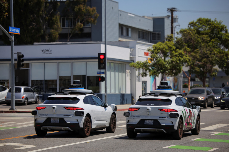 FILE PHOTO: Waymo driverless vehicles wait at a traffic light in Santa Monica, California, U.S., May 30, 2025. REUTERS/Daniel Cole/File Photo