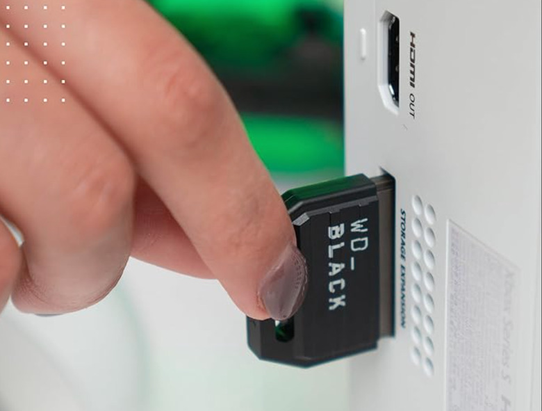 A card sliding into an Xbox.