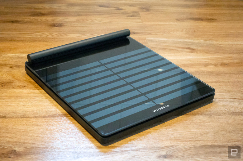 Image of Withings' Body Scan connected health station scale at an angle against a wooden floor in my bathroom.