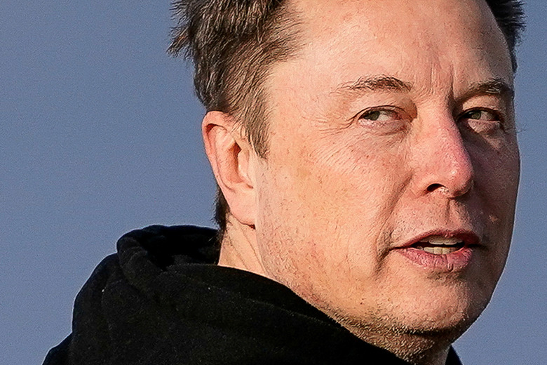 FILE PHOTO: Tesla CEO Elon Musk walks to board Air Force One with U.S. President Donald Trump (not pictured) as they depart for Philadelphia, Pennsylvania, from Morristown Municipal Airport in Morristown, New Jersey, U.S., March 22, 2025. REUTERS/Nathan Howard/File Photo