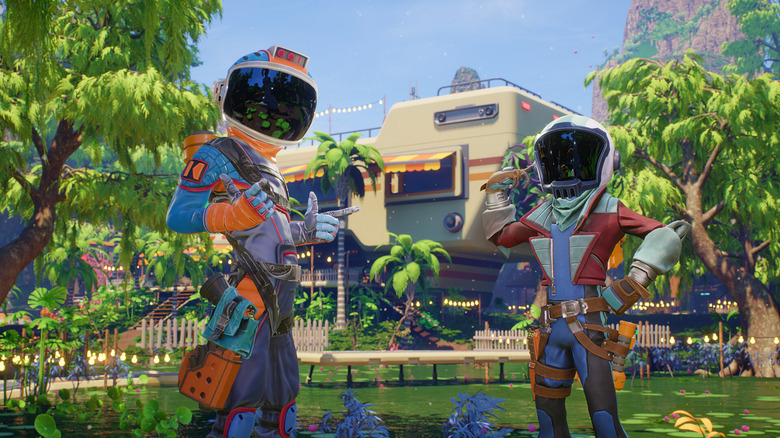 Game screenshot. Two helmeted characters make finger guns as they sit in front of an RV home surrounded by trees.