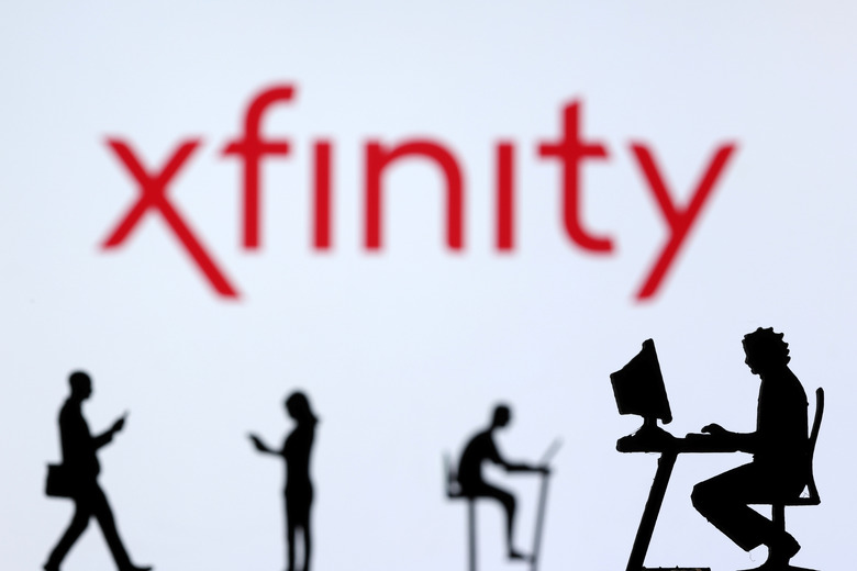 File photo: Small toy figures with laptops and smartphones are seen in front of displayed Xfinity Internet logo, in this illustration taken December 5, 2021. REUTERS/Dado Ruvic/Illustration/File photo