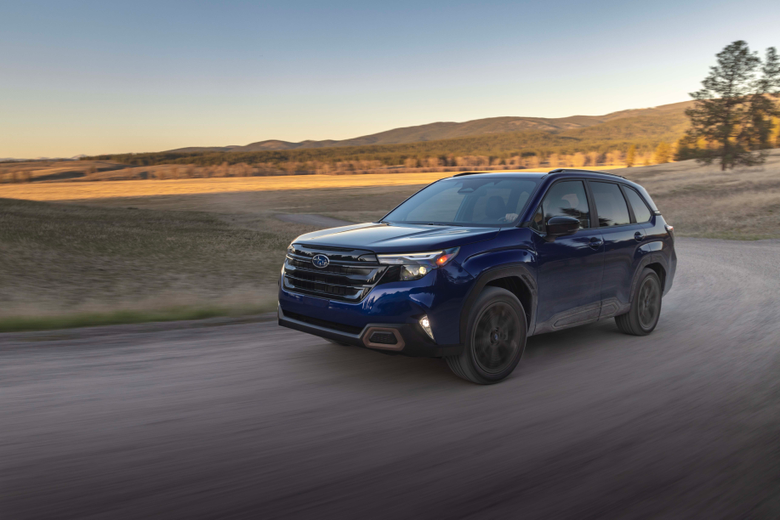 A side-by-side of a silver 2015 Subaru Forester and a blue 2025 Forester